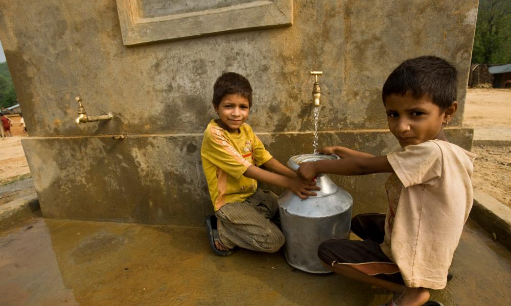 Children collecting spring water from a tap in Nepal Thumbnail