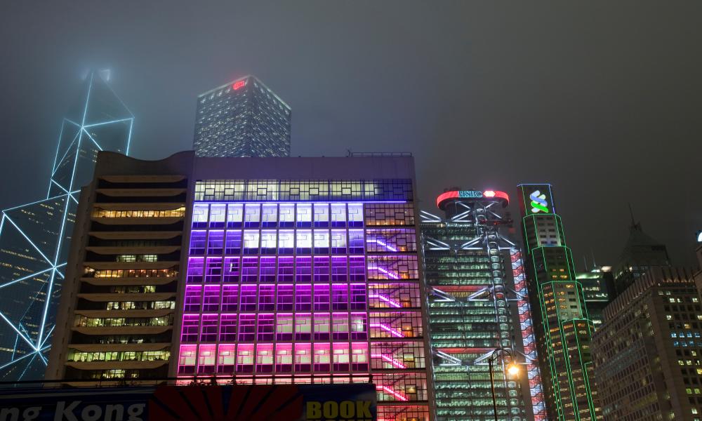 Office blocks lit up at night in Hong Kong, China. Thumbnail