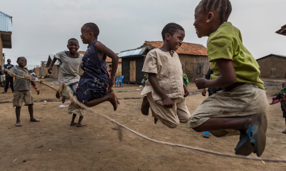 Children jumping and playing in Vitshumbi fishing village on the southern shores of Lake Edward, in the "Block V" area of Virunga National Park, Democratic Republic of Congo.