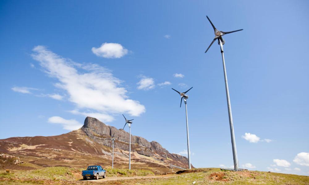 Four wind turbines beneath An Sgurr, Scotland's west coast, UK Thumbnail