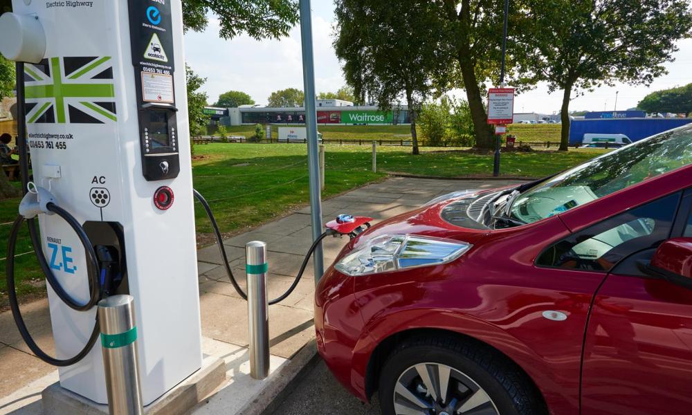 Red Nissan leaf at charge point
