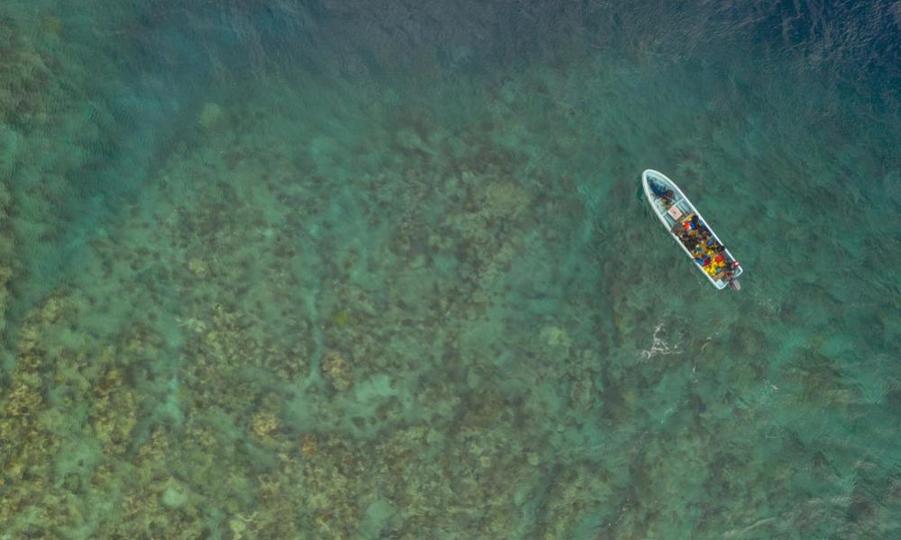 Aerial view of one of the diving skiffs just about to anchor at one of the reef north of Vanua Levu, FIji.