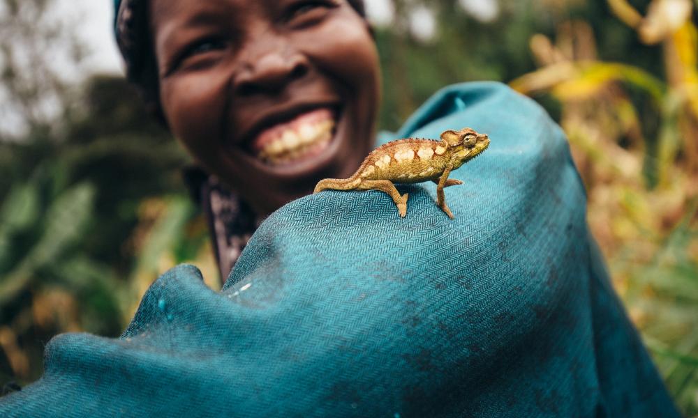 Nancy Rono, Farmer, on her farm with cameleonon on her arm. Bomet County, Mara River Upper Catchment, Kenya