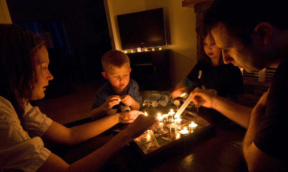 Family sat together, by candlelight