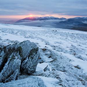 Red Screes above Ambleside with mist from a temperature inversion, Lake District, UK, looking towards Coniston Old Man.