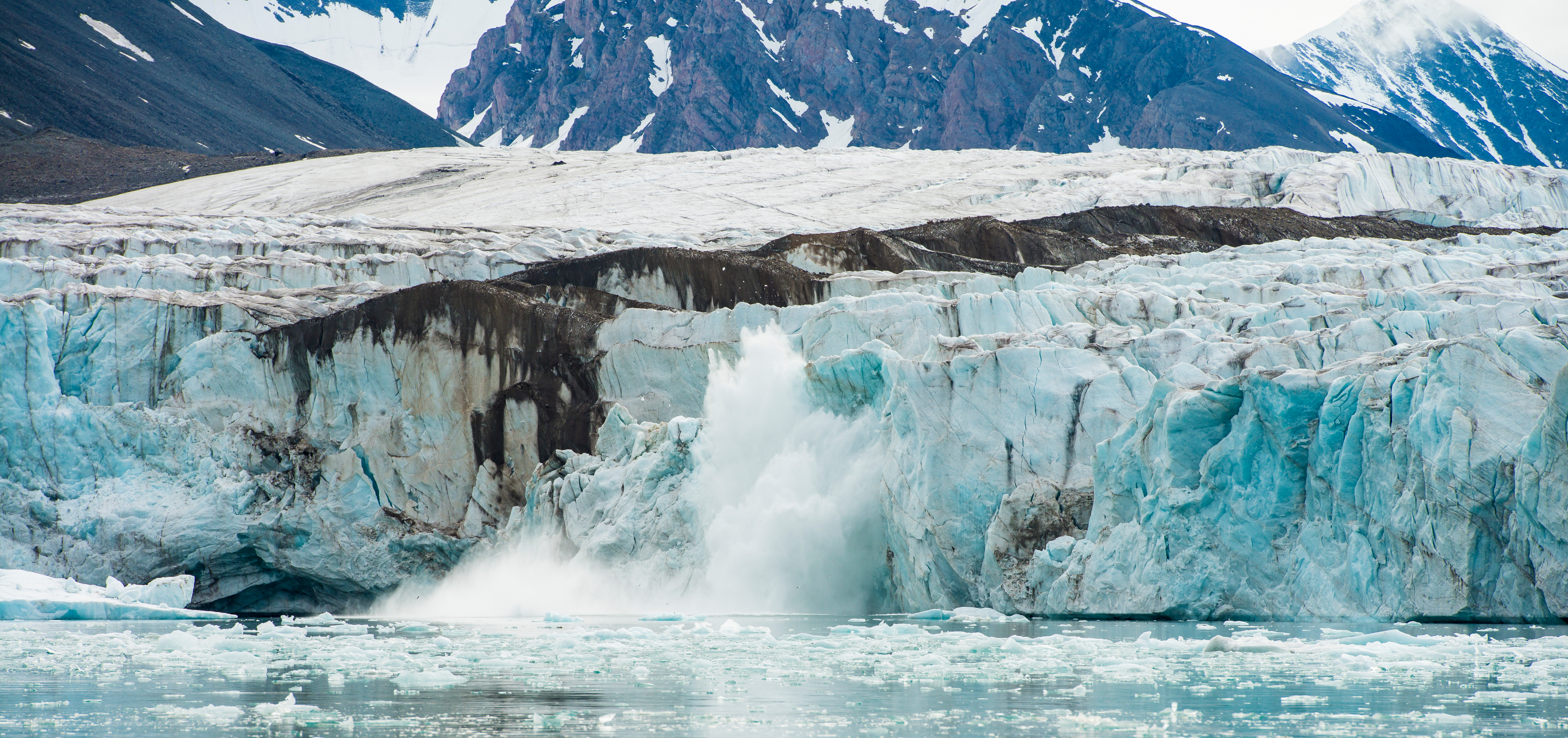 A glacier calving into the ocean