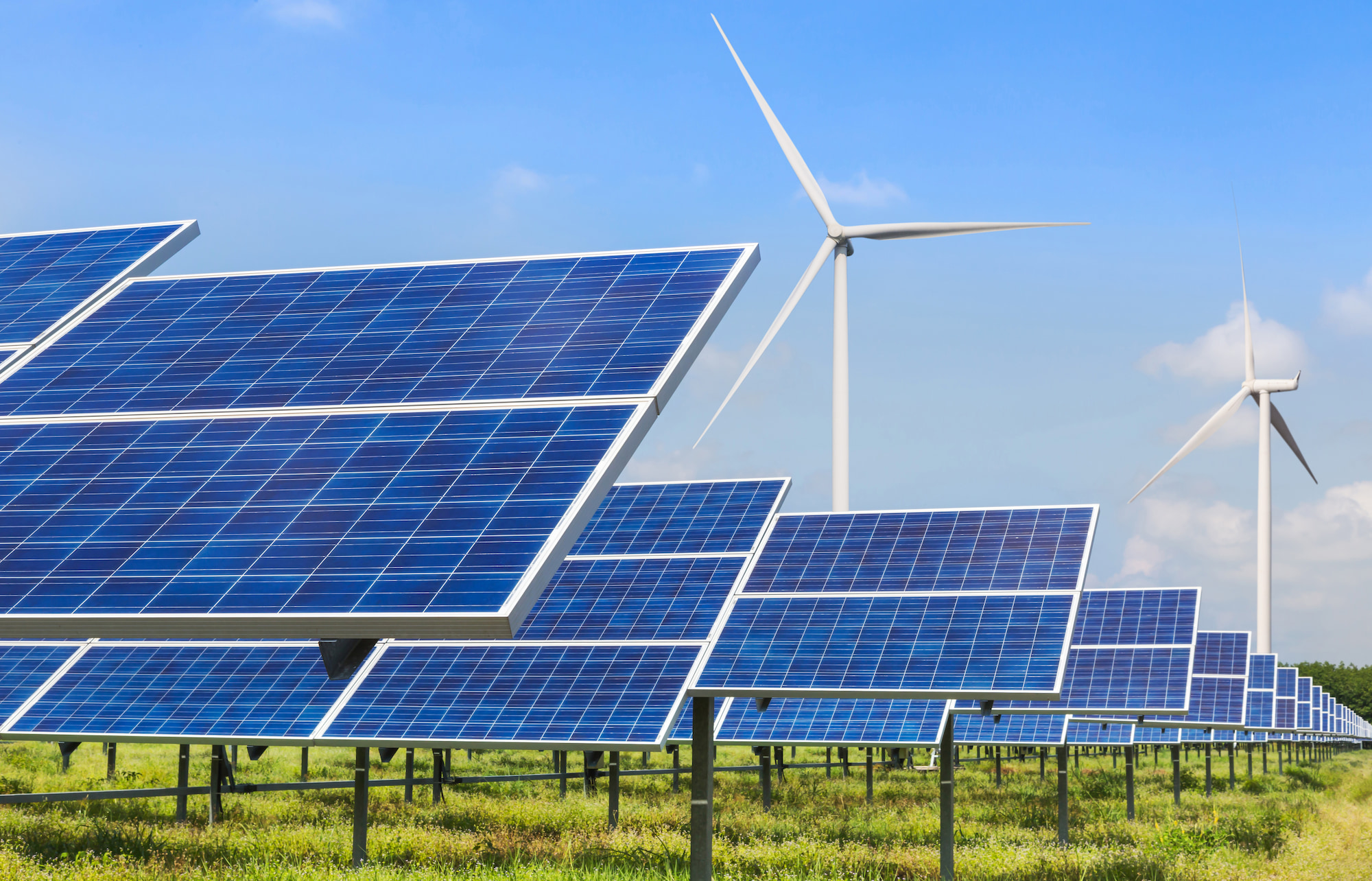 Renewable energy stock image of photovoltaics and wind turbines generating electricity in solar power station.
