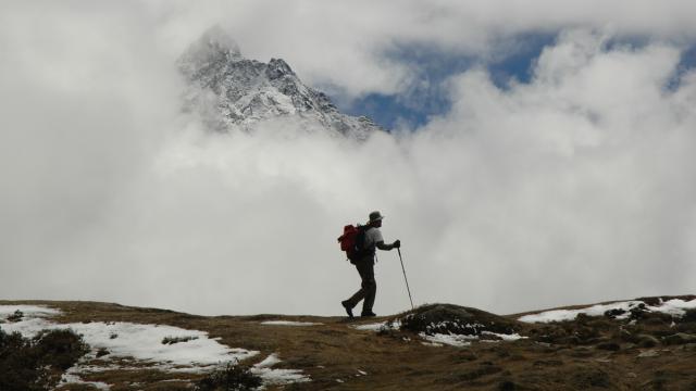 	A lone trekker on a trail in the Himalayas near Mount Everest, Nepal.