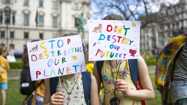 People protesting at an organised UK Student Climate Network strike at Parliament Square, May 2019, London.