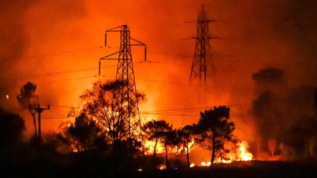 Fire burning through electricity lines and forest