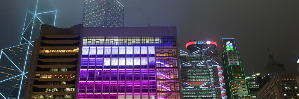 Office blocks lit up at night in Hong Kong, China.