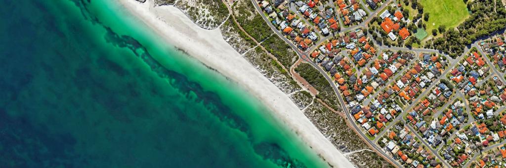 An aerial photograph of houses along the coastline.