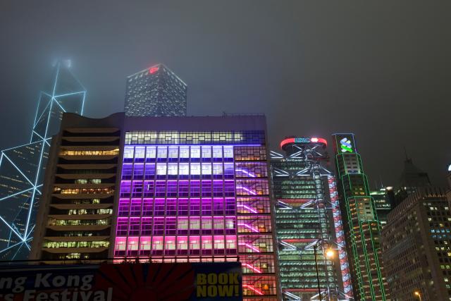 Office blocks lit up at night in Hong Kong, China.
