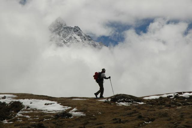  	A lone trekker on a trail in the Himalayas near Mount Everest, Nepal.