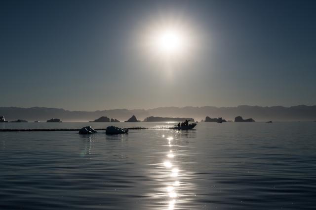 Speedboat in amongst icebergs in the Arctic