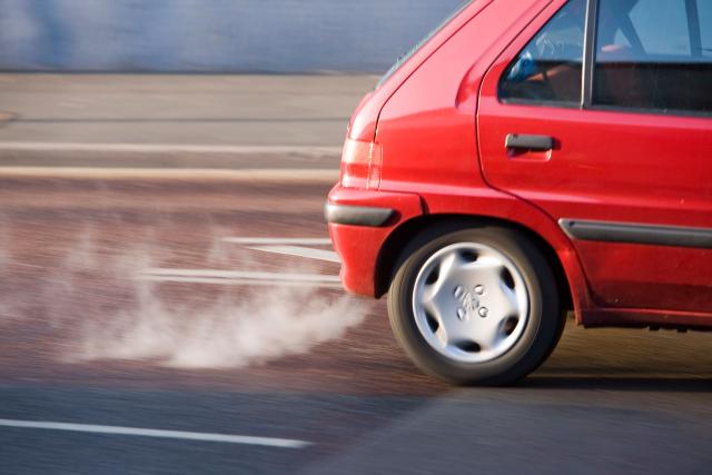 Red car exhaust and fumes