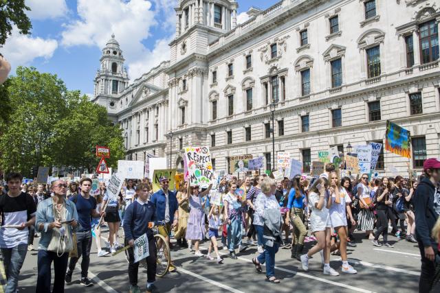 People protesting at an organised UK Student Climate Network strike at Parliament Square, May 2019, London.