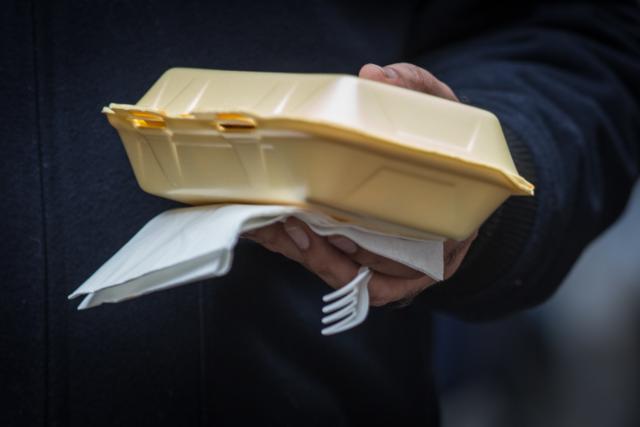 Disposable Plastic cutlery is used at a food market in London, England