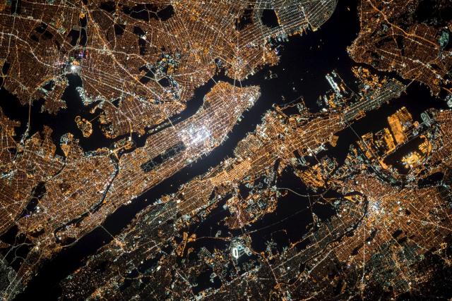 A satellite image of a glowing city at night.