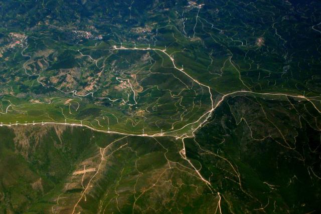 A satellite image of a series of wind turbines on a mountain.