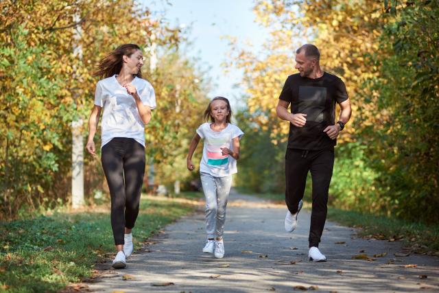 Family of three running in the park 