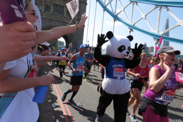 Runner in Panda costume during the London Marathon on Tower Bridge