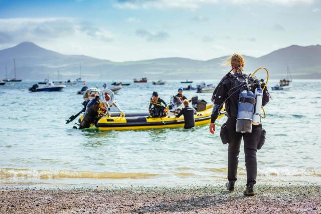 Volunteer divers from project seagrass prepare for the mornings dive to gather seagrass seeds from the seabed. Porthdinllaen, Wales. UK.