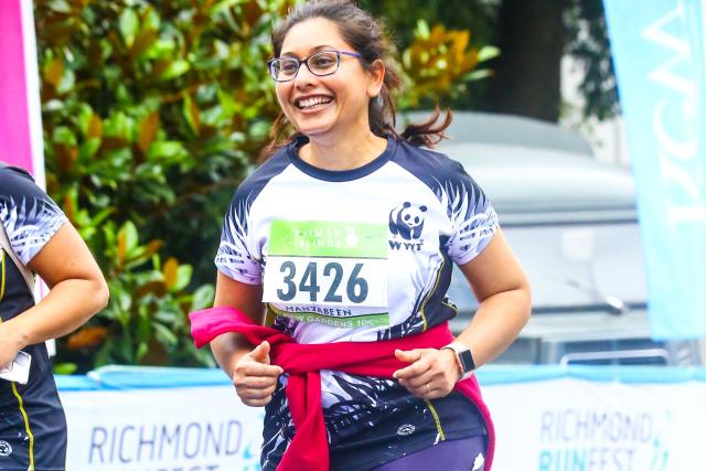WWF runner crossing the finish line at Kew Gardens 10K