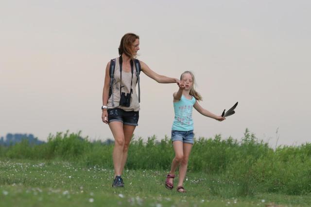 Woman and child walking with binoculars