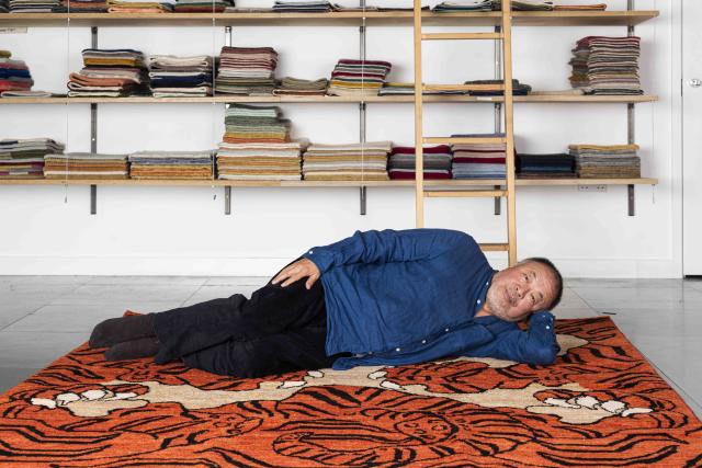 Ai Weiwei laid on his tiger rug