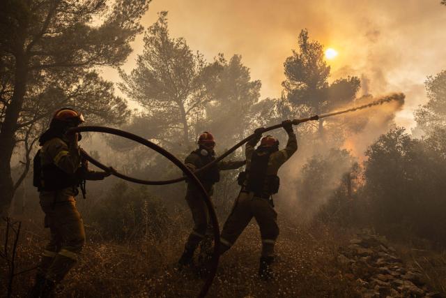 Firefighters battle a wildfire in Agia Sotira, a western suberb of Athens, Greece, on July 20, 2023.