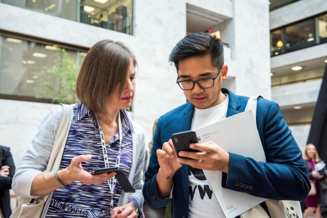 Two people on their mobile phones