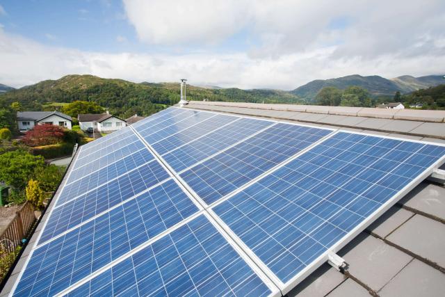 Close up of solar voltaic panels on a house roof in Ambleside, Cumbria, UK