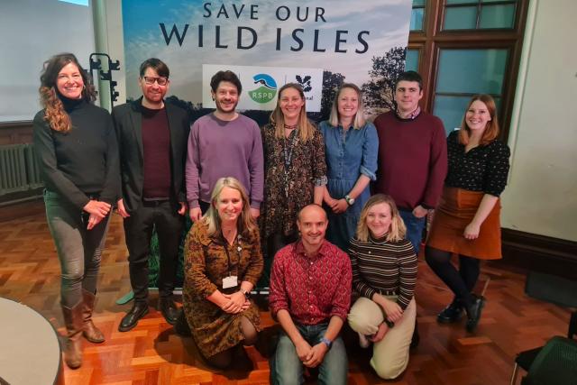 The WWF Cymru team pictured in front of a Save Our Wild Isles board at an event.