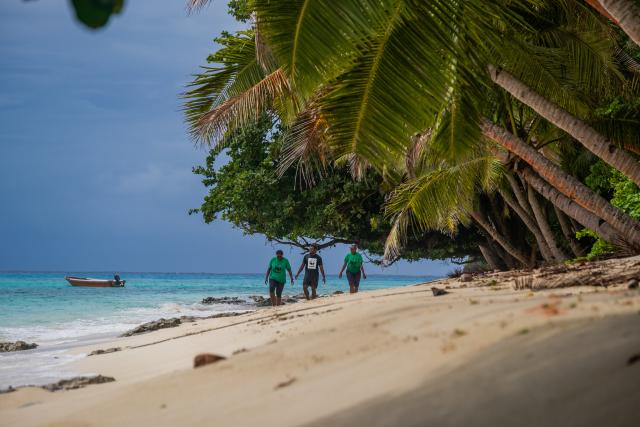 Tuvuca Island, WWF-Pacific volunteers Adi Fulori, Sevanaia Koroisamani and Melea Rakavu [left-right] taking a walk along the beach.