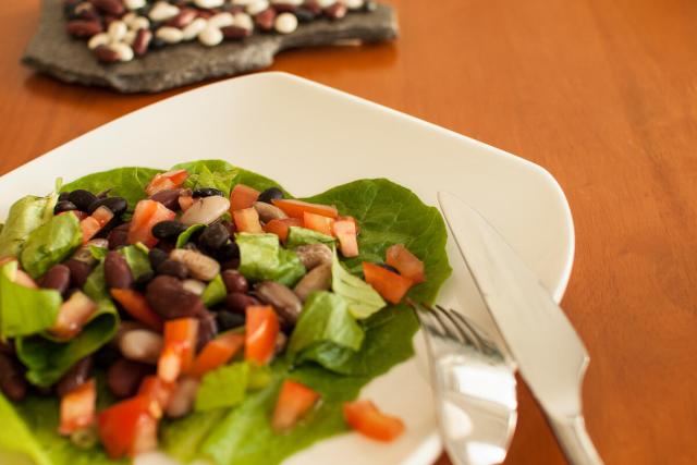 Plated salad with lettuce, chopped tomatoes and beans