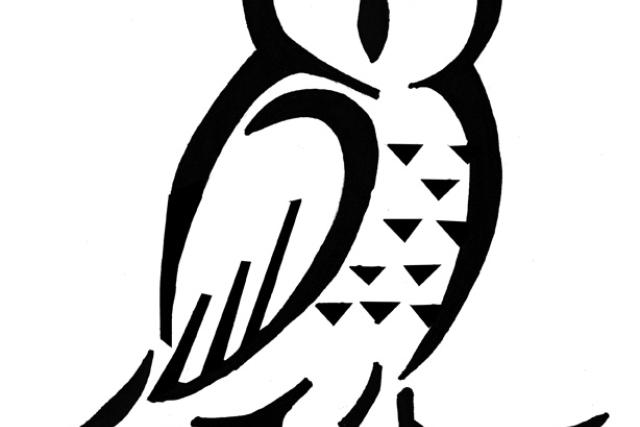 A black pumpkin stencil of an owl