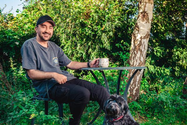 Conor McDonnell and his dog having a cup of tea in the garden
