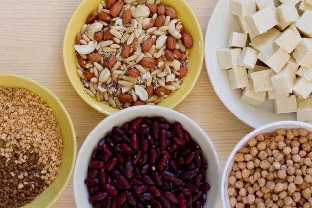 Bowls of nuts, tofu, beans, chickpeas and lentils