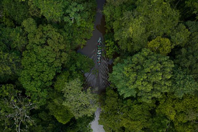 Aerial shot of boat travelling through del Nare Lagoon, located in Guaviare, Colombia.