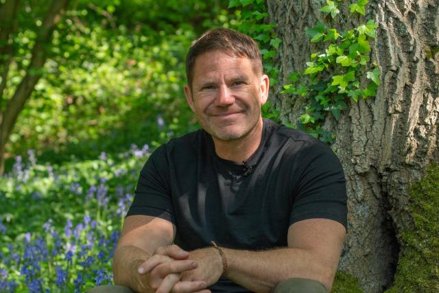 Steve Backshall in a bluebell field