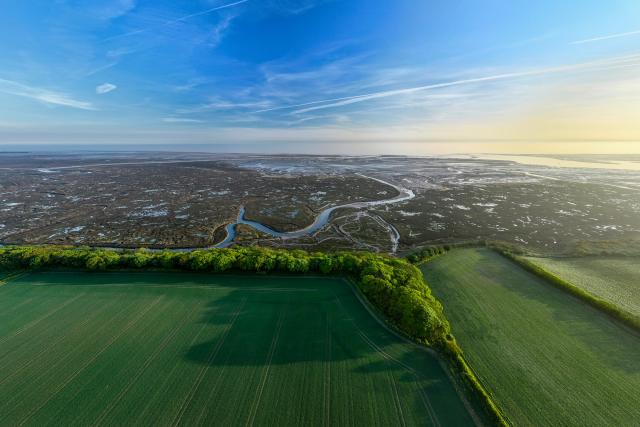 Drone shot of Stiffkey Marshes as tide comes in looking out to ocean. Stiffkey Marshes, Stiffkey, North Norfolk, UK.