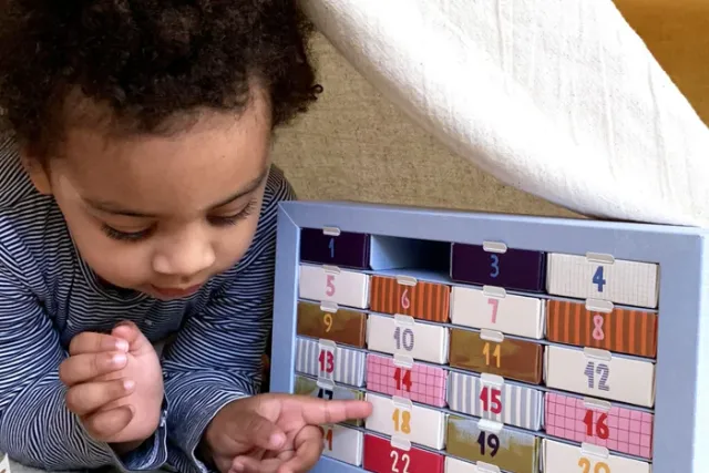 Child next to PLAYin CHOC - Advent Calendar