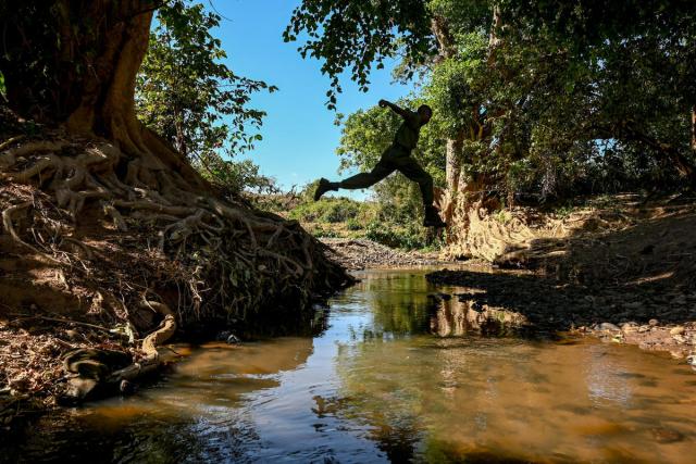 Rangers Musa, Daniel and Solomon, patrol using binoculars and a tracking app near Elangata Enderit village in lower Loita, Kenya.