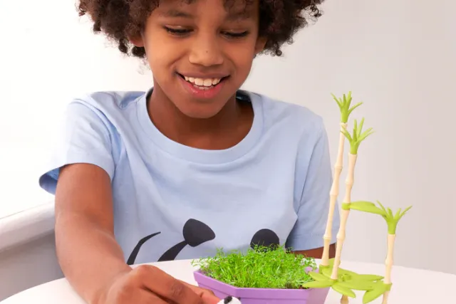 Girl playing with Wild Scenes Grow and Play - Pandas' Bamboo Forest