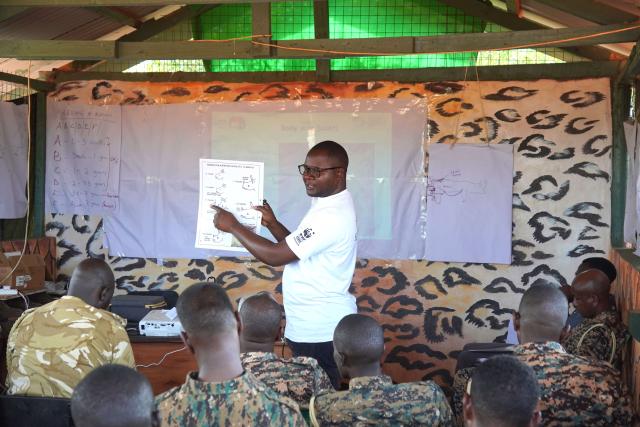 A man teaching a class about rhino monitoring