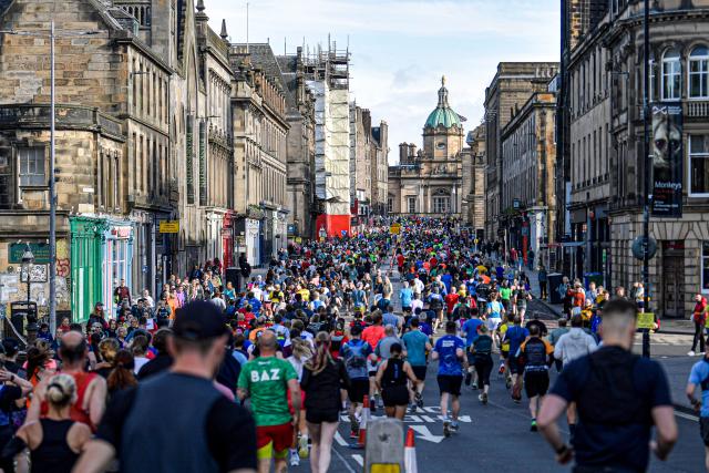 Runners running down the royal mile in Edinburgh