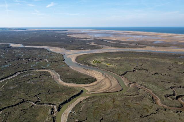 Drone shot of Stiffkey Marshes as tide comes in. Stiffkey Marshes, Stiffkey, North Norfolk, UK.