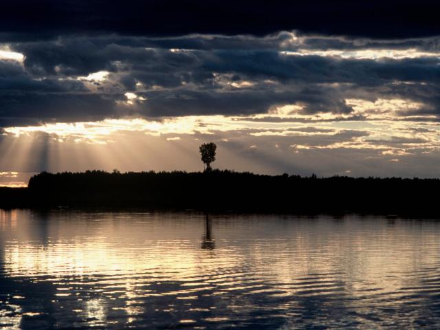 Sun shining through the clouds, Khingansky Zapovednik (Strict Nature Reserve), Amur floodplain. Far East. 