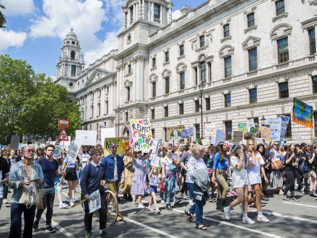 People protesting at an organised UK Student Climate Network strike at Parliament Square, May 2019, London.